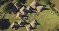 Aerial top down Indonesia farmland with ornated roofs houses at Kodi village landscape, Sumba Island