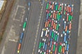 AERIAL: A large group of freight trucks line up before leaving the harbor.