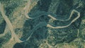 Aerial top down shot of a windy hairpinned car road in mountains