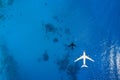 Aerial top down view of an airplane flying over blue sea Royalty Free Stock Photo