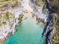 Aerial top down view beautiful beach and water bay in the greek spectacular coast line. Turquoise blue transparent water, unique