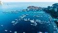 Aerial top down view of boat dock and yacht port in Budva, Montenegro. White private motor boats are moored to pier on Adriatic se Royalty Free Stock Photo