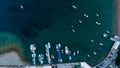 Aerial top down view of boat dock and yacht port in Montenegro. White private motor boats are moored to pier on Adriatic sea coast Royalty Free Stock Photo