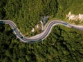 Mountain winding zig zag road. Top aerial view: cars driving on road from above. Royalty Free Stock Photo