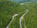 Mountain winding zig zag road. Top aerial view: cars driving on road from above. Royalty Free Stock Photo