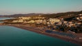 Aerial view sunrise over kiotari beach in Rhodes, greece. Smooth cinematic footage with buildings on the beach front