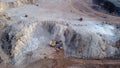 Aerial top down view of an excavator loading crushed stone into a dump truck in a crushed stone quarry Royalty Free Stock Photo