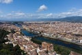Aerial top down view of Florence city Arno river, narrow streets, houses with tiled orange roofs, old town squares, trees, bridges Royalty Free Stock Photo