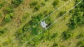 Aerial top down view high voltage steel power pylons in green field countryside. Flight over power transmission lines Royalty Free Stock Photo