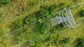 Aerial top down view high voltage steel power pylons in green field countryside. Flight over power transmission lines Royalty Free Stock Photo