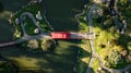 An aerial top-down view on Japanese styled garden with red bridge