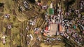 Aerial top-down view of main square at Taquile Island, visible houses, football field, terraced slopes