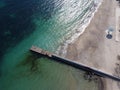 Aerial top down view of old concrete pier or breakwater with emerald sea water Royalty Free Stock Photo