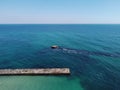 Aerial top down view of old concrete pier or breakwater with emerald sea water Royalty Free Stock Photo