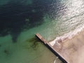 Aerial top down view of old concrete pier or breakwater with emerald sea water Royalty Free Stock Photo
