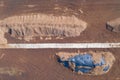 Aerial top down view of peat harvesting field with piles of peat. Peat extraction