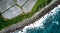 Aerial top-down view on rice paddy fields full of water next to the ocean blue waters