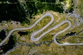 Aerial top down view of serpentine narrow road. A road full of twists and turns winding Royalty Free Stock Photo