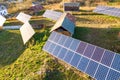 Aerial top down view of solar photo voltaic panels in green rural area. Clean renewable energy in private village environment Royalty Free Stock Photo