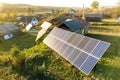 Aerial top down view of solar photo voltaic panels in green rural area. Clean renewable energy in private village environment Royalty Free Stock Photo