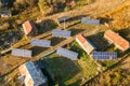 Aerial top down view of solar photo voltaic panels in green rural area. Clean renewable energy in private village environment Royalty Free Stock Photo