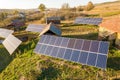 Aerial top down view of solar photo voltaic panels in green rural area. Clean renewable energy in private village environment Royalty Free Stock Photo