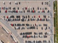 Aerial top down view to parking full of cars