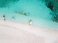 Aerial top down view of white sand beach with a traditional philippine boats beached on it