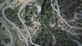 Aerial top-down view of a windy hairpinned car road in mountains in Spain