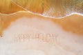 Aerial top shot from ocean waves and handwritten Happy holiday