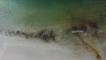 Aerial top shot of the sea washing the sandy coast in Hamaroy, Nordland, Norway