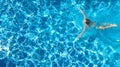 Aerial top view of active woman in swimming pool from above, girl swims in blue water, tropical vacation, holiday on resort Royalty Free Stock Photo