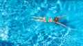 Aerial top view of active woman in swimming pool from above, girl swims in blue water, tropical vacation, holiday on resort Royalty Free Stock Photo
