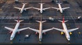 Aerial top view from aircraft window with commercial airplanes parking on runway Royalty Free Stock Photo