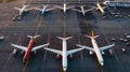 Aerial top view from aircraft window with commercial airplanes parking on runway Royalty Free Stock Photo