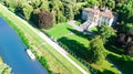Aerial top view of ancient villa Giovanelli, garden and houseboat barge on canal Brenta from above, family vacation cruise on boat