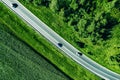 Aerial top view of a asphalt road with a car through .green forest and corn field Royalty Free Stock Photo