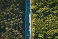 Aerial top view of asphalt road between green summer forest at sunny summer day Royalty Free Stock Photo
