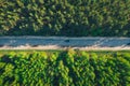 Aerial top view of asphalt road between green summer forest at sunny summer day Royalty Free Stock Photo