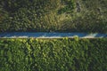 Aerial top view of asphalt road between green summer forest at sunny summer day Royalty Free Stock Photo