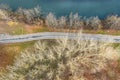 Aerial top view of autumn park landscape. bike lane and footpath on riverbank.