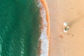 Aerial top view on the beach. Umbrellas, sand and sea waves Royalty Free Stock Photo