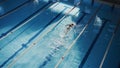 Aerial Top View: Beautiful Female Swimmer in Swimming Pool. Professional Athlete Swims in Freestyle Royalty Free Stock Photo