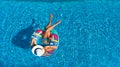 Aerial top view of beautiful girl in swimming pool from above, relax swim on inflatable ring donut and has fun in water Royalty Free Stock Photo