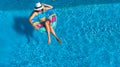 Aerial top view of beautiful girl in swimming pool from above, relax swim on inflatable ring donut and has fun in water Royalty Free Stock Photo