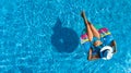 Aerial top view of beautiful girl in swimming pool from above, relax swim on inflatable ring donut in water on family Royalty Free Stock Photo