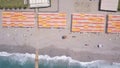 Aerial top view of a blue sea and wooden pier. Clip. Sandy beach with people sunbathing outdoors, concept of summer Royalty Free Stock Photo