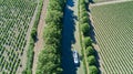 Aerial top view of boat in Canal du Midi from above, family travel by barge and vacation in France Royalty Free Stock Photo