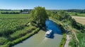 Aerial top view of boat in Canal du Midi from above, family travel by barge and vacation in France Royalty Free Stock Photo