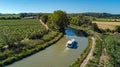 Aerial top view of boat in Canal du Midi from above, travel by barge in Southern France Royalty Free Stock Photo